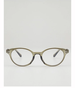 Detail of translucent olive green cat-eye glasses frame with metallic rivet accents