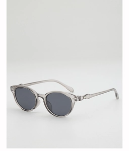 Detail of translucent gray acetate frame and decorative metal diamond hinge on sunglasses