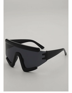 Side view detail of oversized shield sunglasses with a thick modern black plastic frame