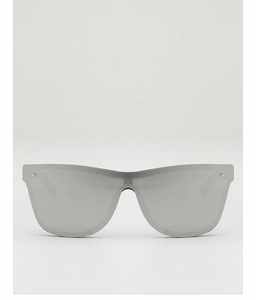 Close-up of frameless shield sunglasses with silver mirrored lenses and metal rivets