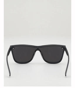 Detail of minimalist black shield sunglasses featuring a wide temple and seamless frame design