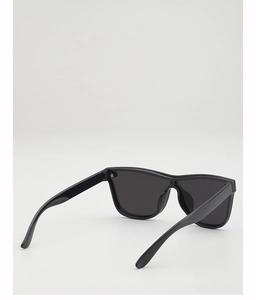 Detail view of the durable hinges and sleek black frames of kids rimless sunglasses