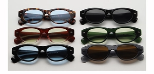 Flat lay of oval cat eye sunglasses in various colors with silver rivet accents