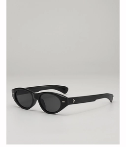 Detail of sleek black cat-eye sunglasses with glossy frames and silver metal studs