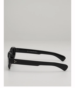 Close-up of black cat-eye sunglasses temple featuring triple star metal rivet details