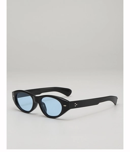 Detail view of black cat-eye sunglasses with blue lenses and silver flower rivets
