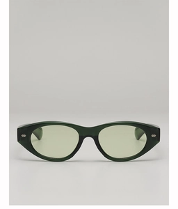 Close-up of green cat-eye sunglasses with silver hexagonal rivets and sea-green lenses