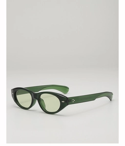 Detail view of green translucent cat eye sunglasses with silver diamond metal rivets