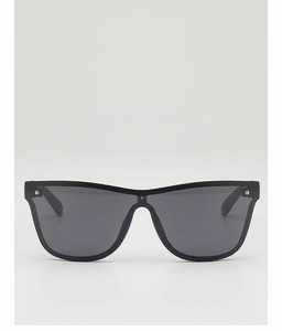 Close-up of black oversized kids sunglasses with silver rivets on a white background