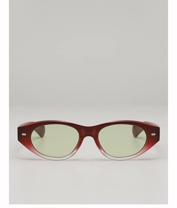 Detail of red gradient cat-eye sunglasses with green lenses and silver rivet accents