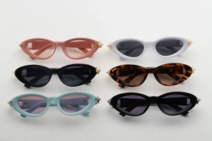 Flat lay of retro cat-eye sunglasses in various colors with golden thorn accents