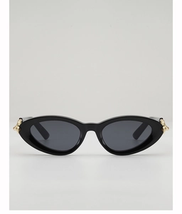 Detail of cat eye sunglasses showing stylish leopard pattern and golden metal twist hinge
