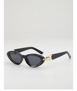 Detail of black cat-eye sunglasses featuring bold gold chain temples and metallic accents