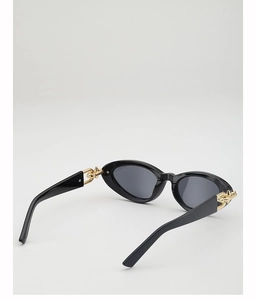 Detail view of cat eye sunglasses with golden chain and punk rivet embellishments