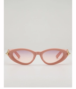 Detail of pink cat-eye sunglasses featuring gradient lenses and gold metal accents