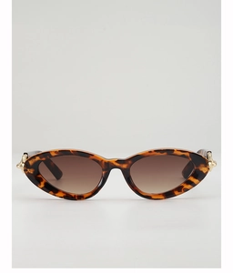 Detail of tortoiseshell cat-eye sunglasses with brown gradient lenses and gold hinges