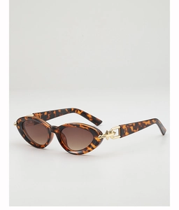 Detail of tortoise shell cat-eye sunglasses with elegant gold metal ring hinge decoration