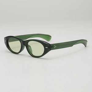 Retro dark green translucent cat eye sunglasses with light yellow lenses and silver rivets