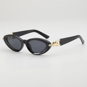 Fashionable black cat eye sunglasses with gold metal hardware and dark gray lenses