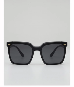 Detailed close-up of thick black square frame sunglasses with gold temple accents
