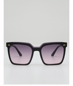 Detail of square black sunglasses with purple gradient lenses and gold metal rivets