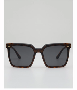 Detail of square oversized tortoise shell sunglasses with chic gold metal accents
