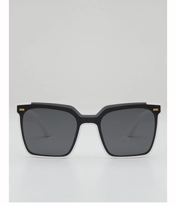 Detail of square sunglasses with black and white frame and gold metal accents