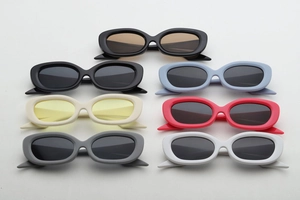 Detailed flat lay of slim oval vintage sunglasses in seven various vibrant colors