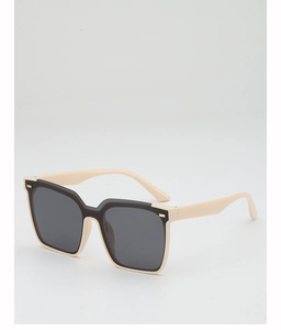 Detail of square oversized cream and black sunglasses with gold metal accents