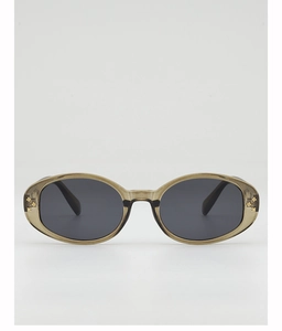 Detail of oval sunglasses showing translucent frame and golden flower rivets