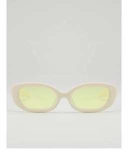 Detailed close-up of oval cream frames and bright yellow lenses of vintage sunglasses