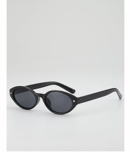 Detail of oval black sunglasses with small silver star accents on the frame edges