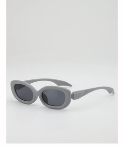 Detail view of grey oval sunglasses with matte finish frames and UV-protective dark lenses