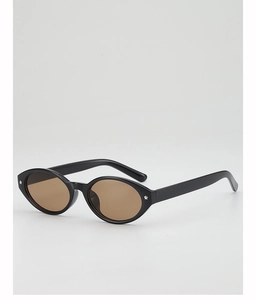 Macro view of oval sunglasses featuring silver star accents on a polished black frame