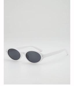 Close-up of white oval frame sunglasses with dark lenses and star metal accents