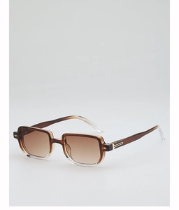 Detail view of square gradient brown sunglasses with gold metal accents on the frame corners