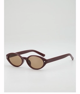 Detail of burgundy oval sunglasses with light brown lenses and silver star decorations