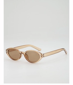 Close-up of translucent amber oval sunglasses with sleek brown lenses and smooth finish