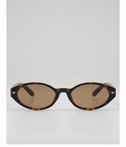 Detail of tortoise shell oval sunglasses featuring silver star accents and brown lenses