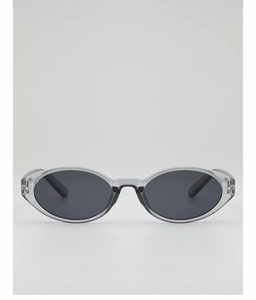 Detail of translucent grey oval sunglasses featuring silver star rivets on the frame