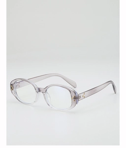 Detail of translucent gray oval sunglasses with decorative gold cross rivets on the frame