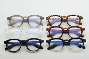 Macro display of round frame sunglasses in various colors including tortoiseshell and black