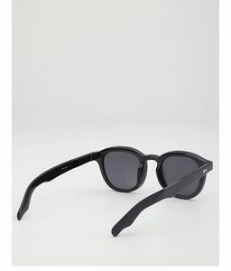 Detail shot of black round sunglasses model WF1230 showing the metal hinge and dark lenses