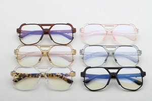 Detail view of large aviator sunglasses in six assorted colors showing dual beam frame