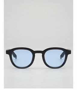 Detail of round black frame sunglasses featuring translucent light blue lenses and sleek finish