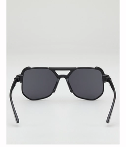 Close-up of black oversized aviator sunglasses with a modern double bridge and dark lenses