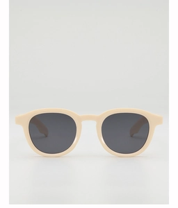 Detail of retro round sunglasses with cream matte frames and dark grey lenses