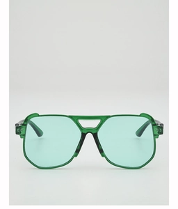 Detail of oversized retro sunglasses featuring ocean green lenses and aviator hollow bridge