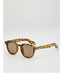 Detail view of round tortoise shell sunglasses featuring vintage metal rivets and brown lenses
