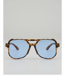 Detailed view of oversized tortoiseshell sunglasses with translucent blue lenses